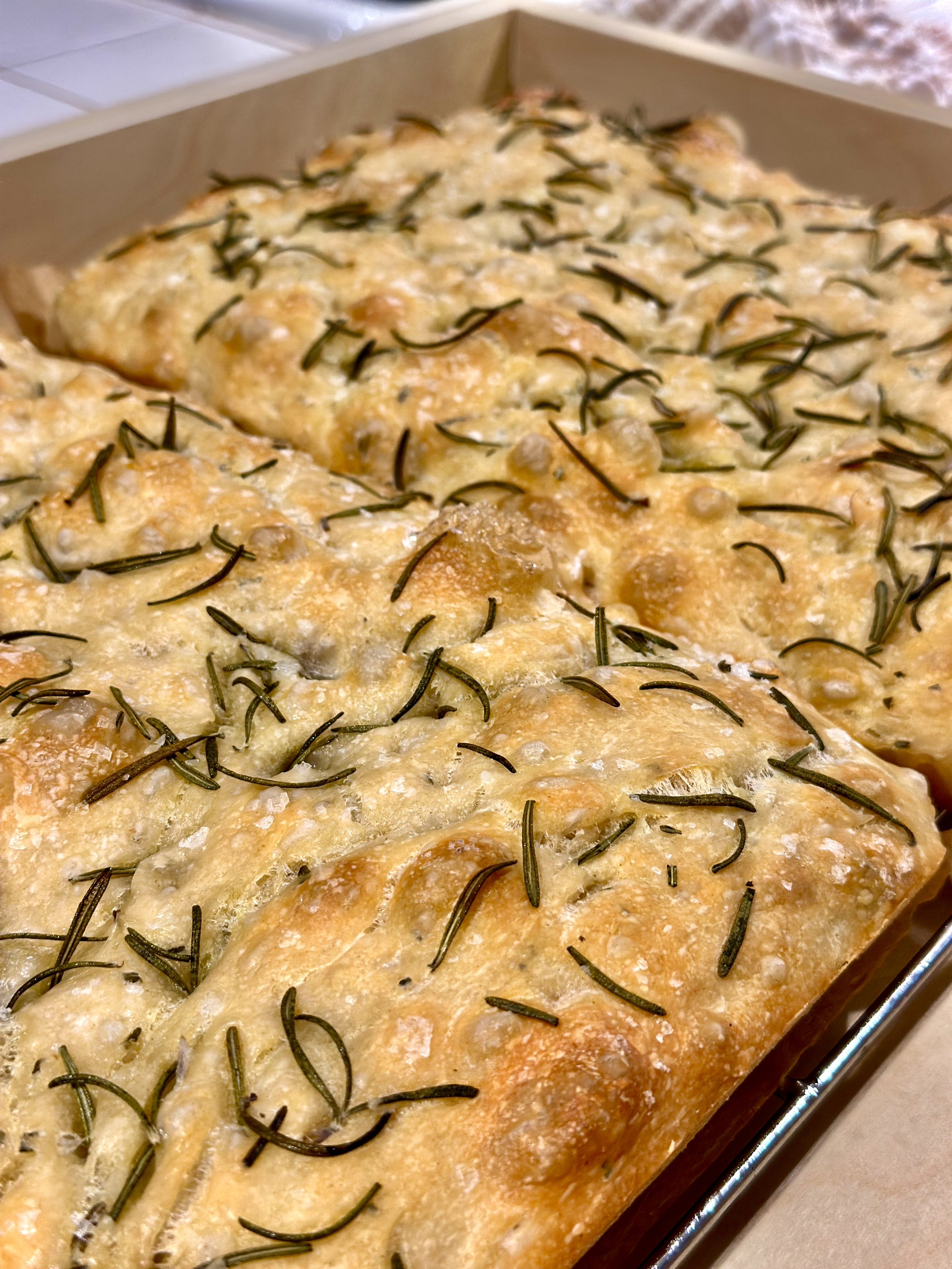 Freshly baked herb focaccia in a pan